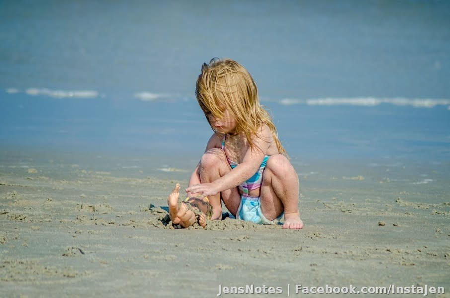 Burying baby in sand!