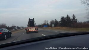 Nothing more pure Michigan then a pure Michigan sign and a semi with vehicle chassis on it lol
